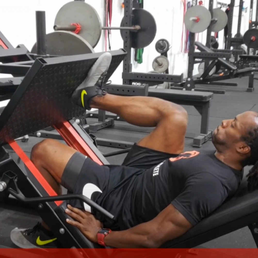 An athlete performing a single-leg leg press.